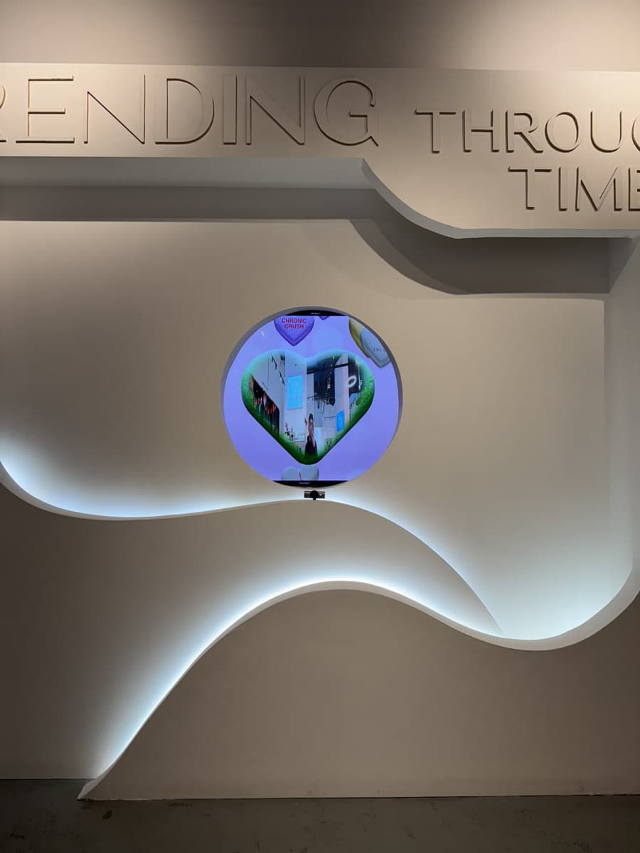 The circular AR mirror display embedded in the wall at Trends