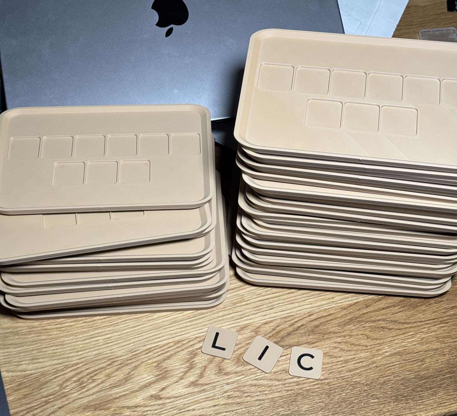 3D printed tray pieces in production on desk