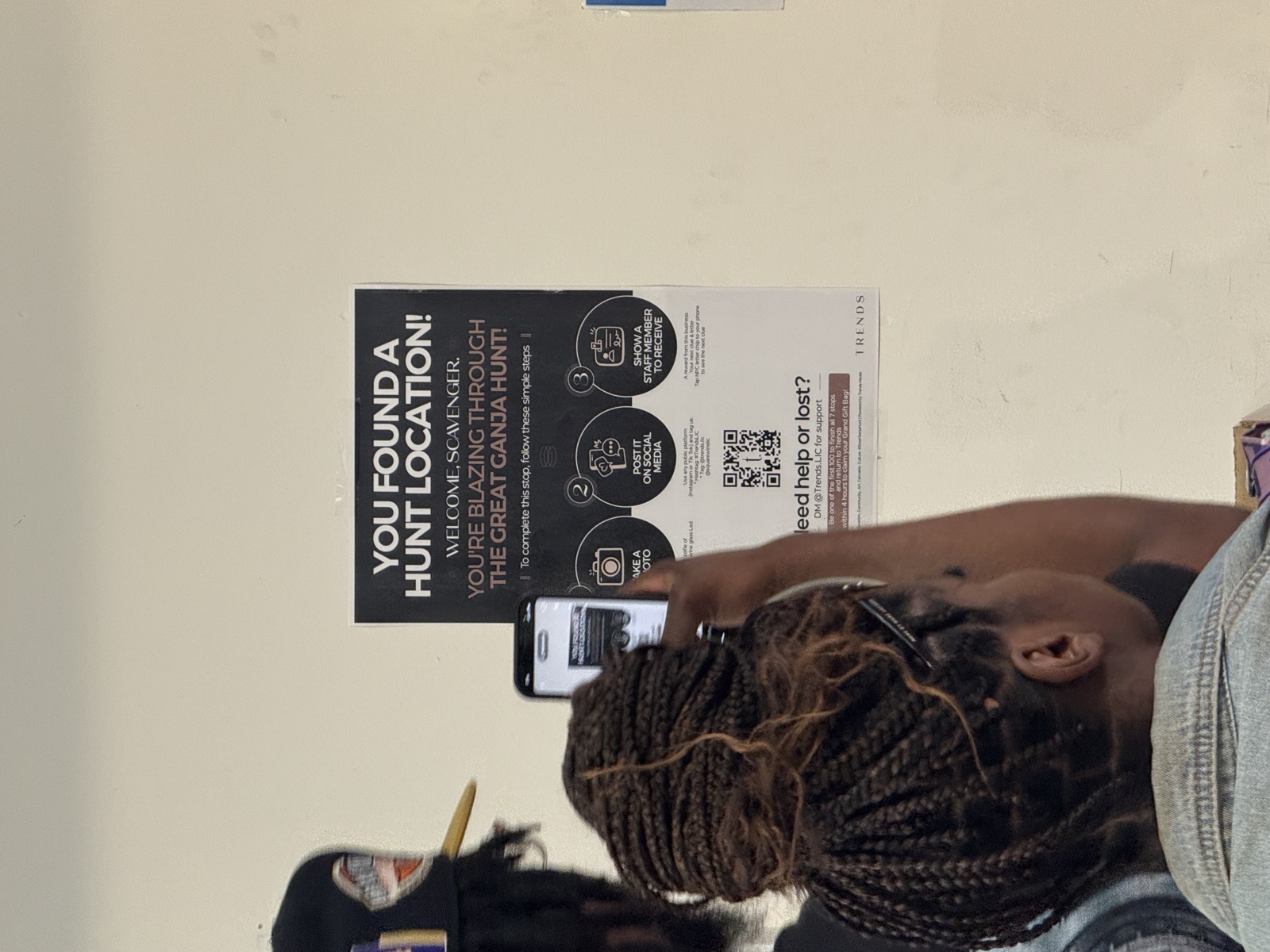 Participant finding a hunt location poster with QR code